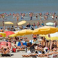 Tourists sunbathing at the North Sea beach in summer, Blankenberge, Belgium
